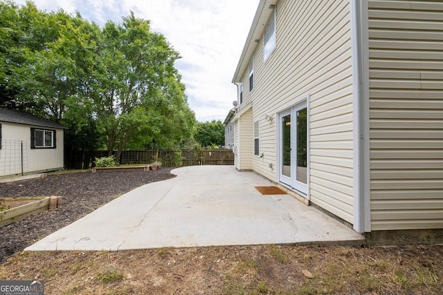 1186 Hawthorn Ln, Grayson, GA 30017 - fenced backyard with a patio area, a shed, and french doors