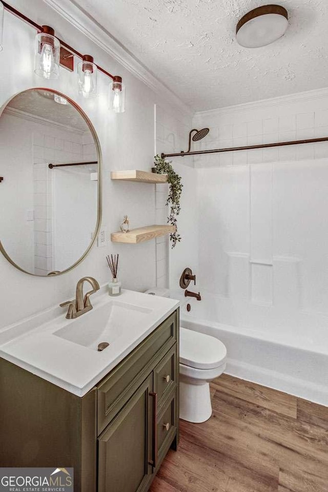 2572 Bates St SE, Smyrna, GA 30080 - full bathroom featuring ornamental molding, toilet, vanity, a textured ceiling, and bathtub / shower combination