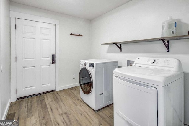 2572 Bates St SE, Smyrna, GA 30080 - laundry room featuring washing machine and clothes dryer, light wood-style flooring, and baseboards