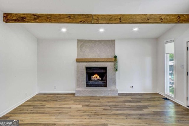 2572 Bates St SE, Smyrna, GA 30080 - unfurnished living room with wood finished floors, a fireplace, beamed ceiling, baseboards, and recessed lighting
