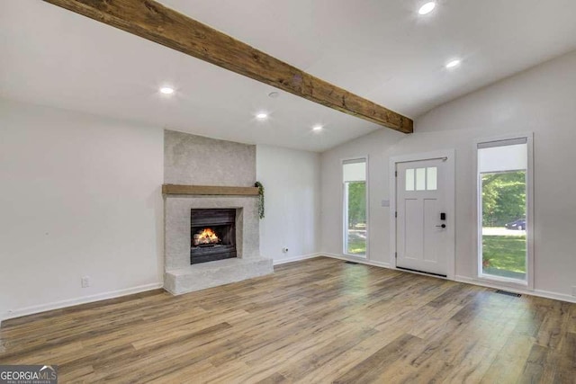 2572 Bates St SE, Smyrna, GA 30080 - unfurnished living room with wood finished floors, recessed lighting, healthy amount of natural light, baseboards, and a fireplace