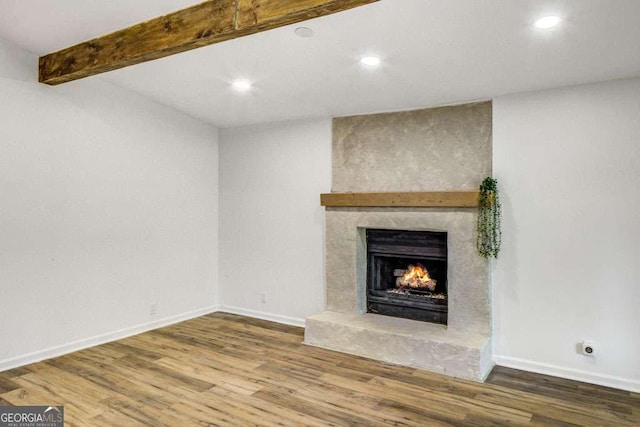2572 Bates St SE, Smyrna, GA 30080 - unfurnished living room with a lit fireplace, wood finished floors, recessed lighting, baseboards, and beamed ceiling