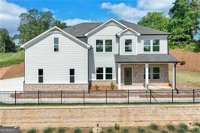 1226 Bloomsbury Ln, Gainesville, GA 30501 - view of front of house featuring brick siding, board and batten siding, a patio, and a fenced backyard