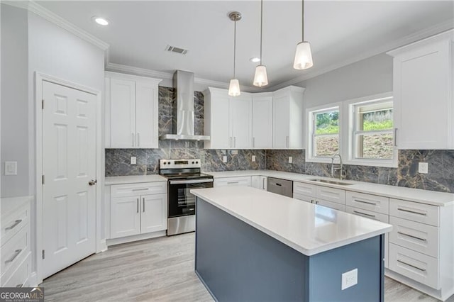 1226 Bloomsbury Ln, Gainesville, GA 30501 - kitchen featuring appliances with stainless steel finishes, wall chimney range hood, crown molding, white cabinetry, and light wood-type flooring