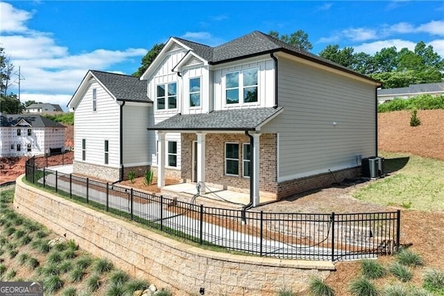 1226 Bloomsbury Ln, Gainesville, GA 30501 - rear view of property featuring a fenced backyard, a patio area, brick siding, board and batten siding, and a shingled roof