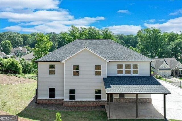 1226 Bloomsbury Ln, Gainesville, GA 30501 - back of house featuring a patio area, a shingled roof, and brick siding