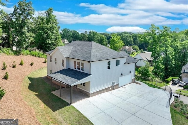 1226 Bloomsbury Ln, Gainesville, GA 30501 - back of house with roof with shingles, a garage, a yard, and driveway