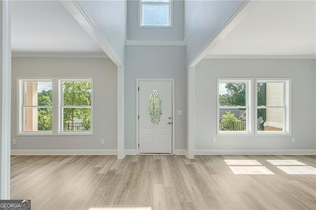 1226 Bloomsbury Ln, Gainesville, GA 30501 - entryway with light wood finished floors, ornamental molding, and a towering ceiling