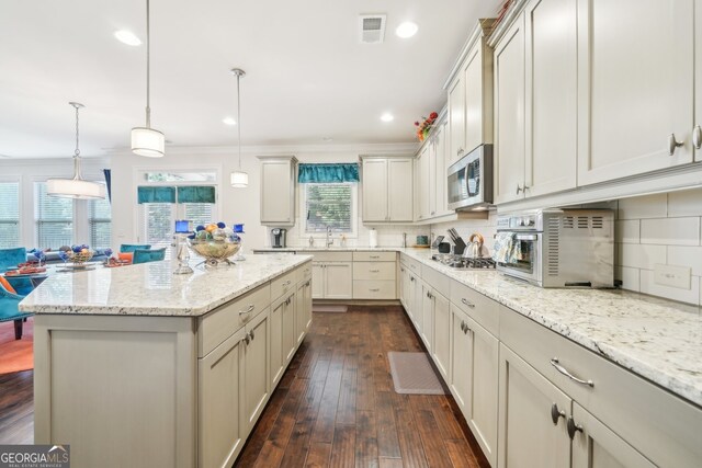 925 Hargrove Point Way, Alpharetta, GA 30004 - kitchen featuring stainless steel appliances, decorative backsplash, a center island, dark wood finished floors, and light stone countertops