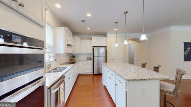 1391 Crooked Creek Rd, Greensboro, GA 30642 - kitchen with stainless steel appliances, a sink, crown molding, decorative backsplash, and white cabinetry