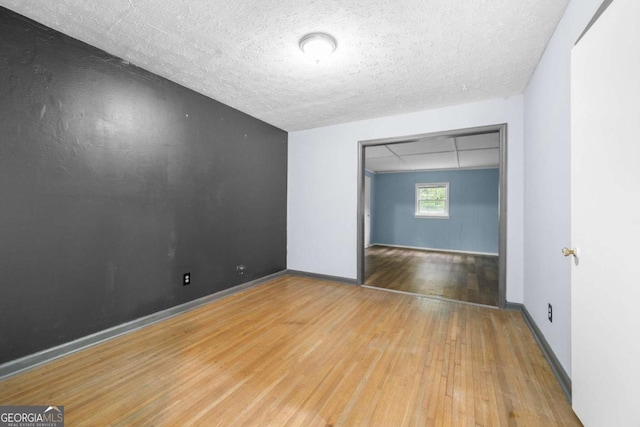 3664 Pin Oak Cir, Atlanta, GA 30340 - unfurnished room featuring hardwood / wood-style floors and a textured ceiling