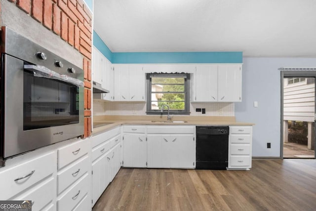 3664 Pin Oak Cir, Atlanta, GA 30340 - kitchen with black dishwasher, oven, light countertops, and wood finished floors