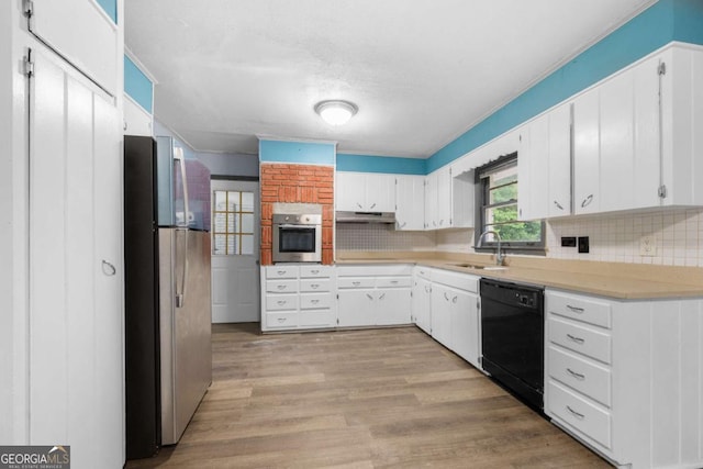 3664 Pin Oak Cir, Atlanta, GA 30340 - kitchen featuring appliances with stainless steel finishes, tasteful backsplash, light countertops, under cabinet range hood, and white cabinets