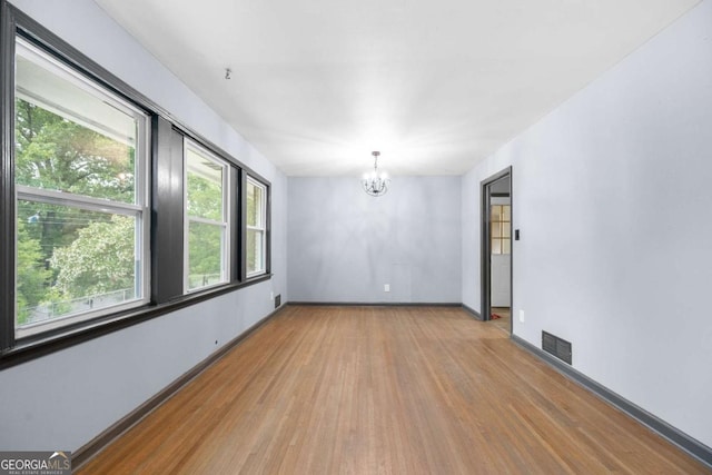 3664 Pin Oak Cir, Atlanta, GA 30340 - unfurnished room featuring light wood-style flooring and a chandelier