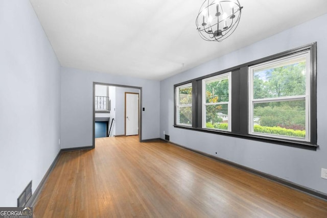 3664 Pin Oak Cir, Atlanta, GA 30340 - empty room with wood finished floors and a chandelier
