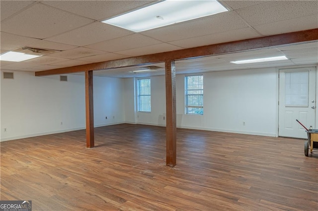 726 Mcdaniel Mill Rd SW, Conyers, GA 30094 - basement featuring a drop ceiling, wood finished floors, and baseboards