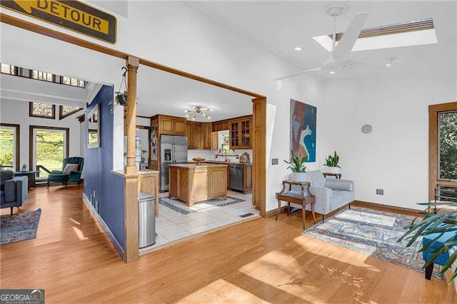 10845 Shallowford Rd, Roswell, GA 30075 - living area with light wood-style flooring, ceiling fan, a towering ceiling, decorative columns, and recessed lighting