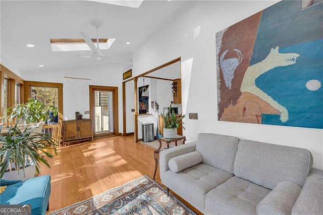 10845 Shallowford Rd, Roswell, GA 30075 - living room with a skylight, wood finished floors, recessed lighting, and vaulted ceiling