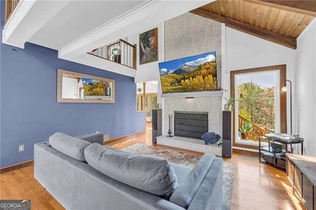 10845 Shallowford Rd, Roswell, GA 30075 - living room featuring wood finished floors, a fireplace with raised hearth, high vaulted ceiling, and a wooden ceiling with exposed beams