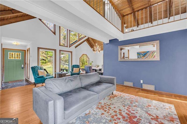 10845 Shallowford Rd, Roswell, GA 30075 - living area featuring high vaulted ceiling, wood finished floors, a chandelier, and a wooden ceiling with exposed beams