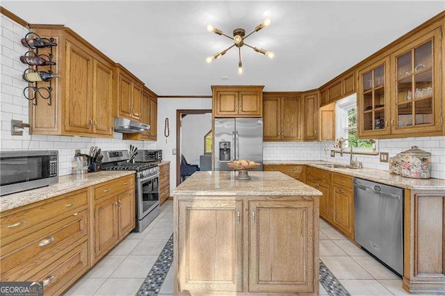 10845 Shallowford Rd, Roswell, GA 30075 - kitchen featuring appliances with stainless steel finishes, under cabinet range hood, tasteful backsplash, and light tile patterned floors