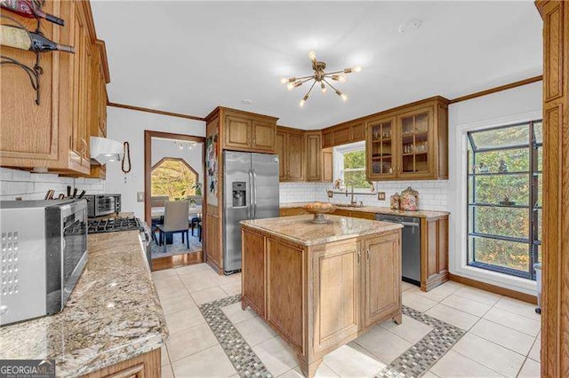 10845 Shallowford Rd, Roswell, GA 30075 - kitchen featuring stainless steel appliances, backsplash, light tile patterned flooring, light stone counters, and crown molding