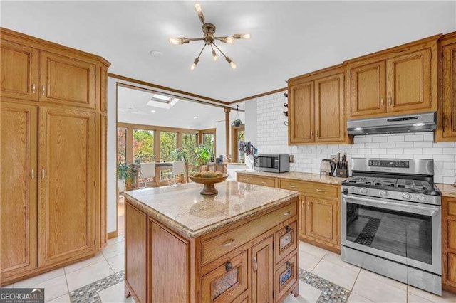 10845 Shallowford Rd, Roswell, GA 30075 - kitchen featuring under cabinet range hood, stainless steel appliances, light tile patterned flooring, and brown cabinets