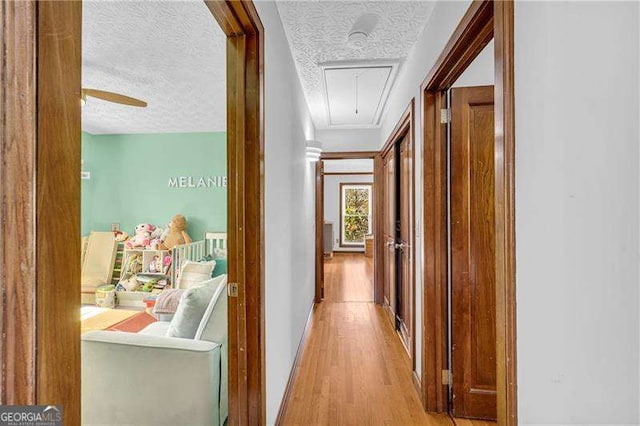 10845 Shallowford Rd, Roswell, GA 30075 - corridor with attic access, wood finished floors, and a textured ceiling