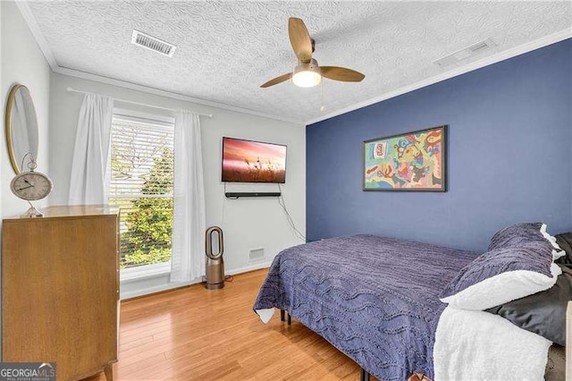 10845 Shallowford Rd, Roswell, GA 30075 - bedroom with wood finished floors, a ceiling fan, a textured ceiling, and crown molding