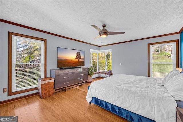 10845 Shallowford Rd, Roswell, GA 30075 - bedroom with light wood finished floors, a textured ceiling, a ceiling fan, and ornamental molding