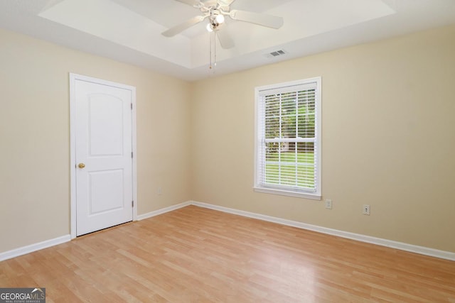 101 Coldbrook Cir, Rincon, GA 31326 - spare room with light wood-style floors, a raised ceiling, and ceiling fan