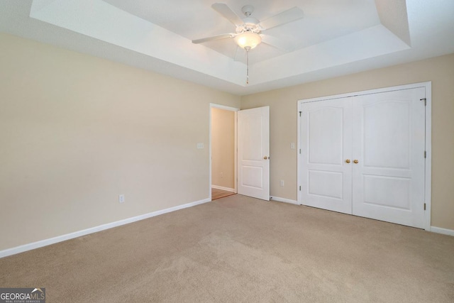 101 Coldbrook Cir, Rincon, GA 31326 - unfurnished bedroom with a raised ceiling, carpet floors, a closet, and a ceiling fan