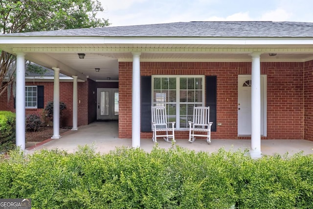 101 Coldbrook Cir, Rincon, GA 31326 - entrance to property featuring brick siding, covered porch, and roof with shingles