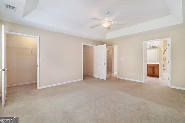 101 Coldbrook Cir, Rincon, GA 31326 - unfurnished bedroom featuring a spacious closet, a raised ceiling, light colored carpet, and ensuite bath