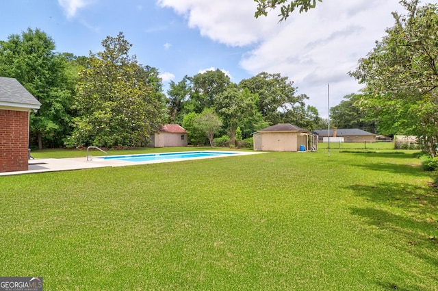 101 Coldbrook Cir, Rincon, GA 31326 - view of green lawn featuring a shed, an outdoor pool, and view of wooded area