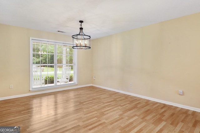 101 Coldbrook Cir, Rincon, GA 31326 - empty room featuring light wood-style flooring and a chandelier
