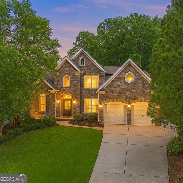 5705 Registry Oaks Ln SE, Mableton, GA 30126 - view of front of home with stone siding, driveway, and a front yard