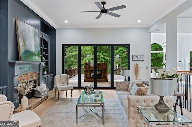 5705 Registry Oaks Ln SE, Mableton, GA 30126 - living room featuring a fireplace with raised hearth, a ceiling fan, light wood finished floors, crown molding, and recessed lighting
