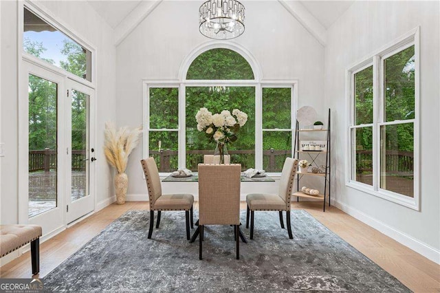 5705 Registry Oaks Ln SE, Mableton, GA 30126 - dining room featuring high vaulted ceiling, plenty of natural light, a chandelier, and wood finished floors