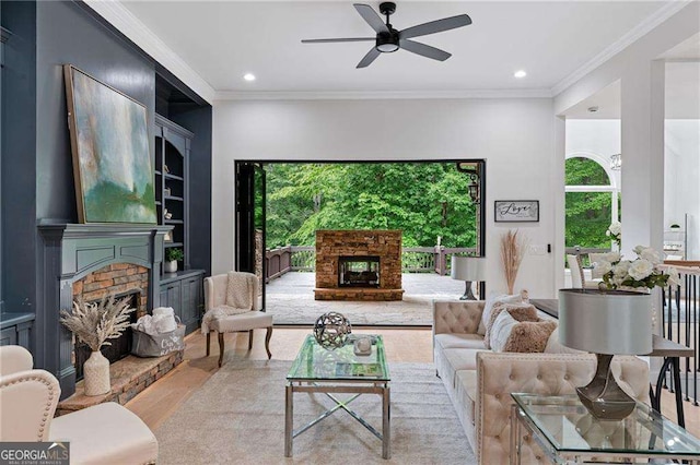 5705 Registry Oaks Ln SE, Mableton, GA 30126 - living area featuring a fireplace, ceiling fan, wood finished floors, ornamental molding, and recessed lighting