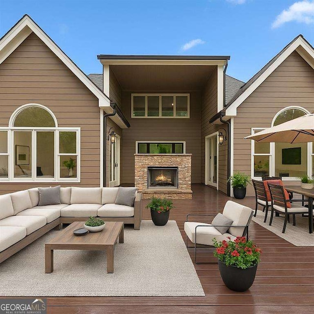 5705 Registry Oaks Ln SE, Mableton, GA 30126 - rear view of house with an outdoor living space with a fireplace, a wooden deck, stone siding, and outdoor dining area