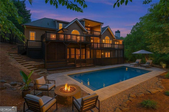 5705 Registry Oaks Ln SE, Mableton, GA 30126 - rear view of property with a balcony, an outdoor fire pit, stairway, a patio area, and an outdoor pool