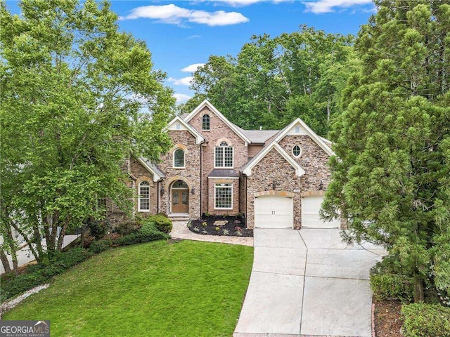 5705 Registry Oaks Ln SE, Mableton, GA 30126 - traditional-style house with driveway, a front yard, an attached garage, stone siding, and brick siding