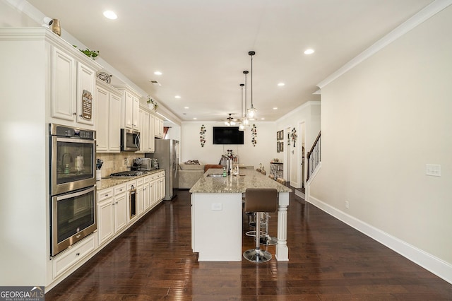 6861 Louis Dr, Locust Grove, GA 30248 - kitchen with stainless steel appliances, a kitchen island with sink, decorative backsplash, recessed lighting, and a breakfast bar area
