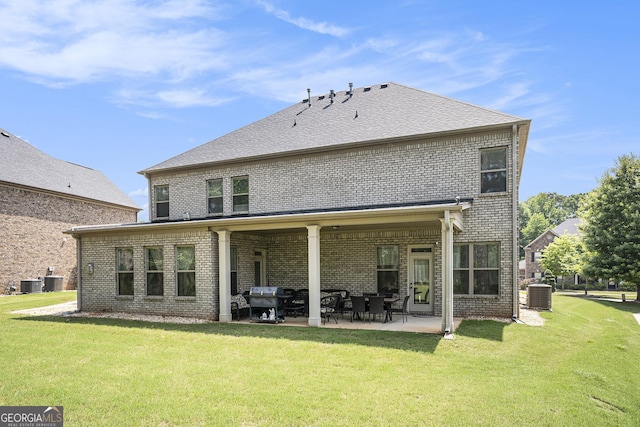 6861 Louis Dr, Locust Grove, GA 30248 - back of property with a patio, brick siding, a lawn, and cooling unit