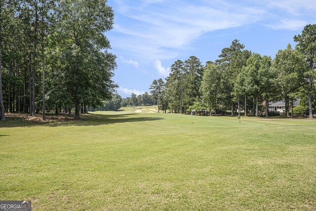 6861 Louis Dr, Locust Grove, GA 30248 - view of community with a yard and view of wooded area