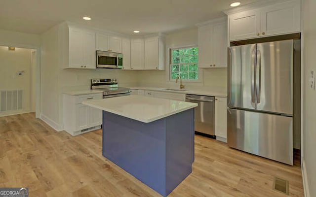 340 Currahee Trl, Toccoa, GA 30577 - kitchen with stainless steel appliances, white cabinetry, light countertops, light wood-type flooring, and recessed lighting