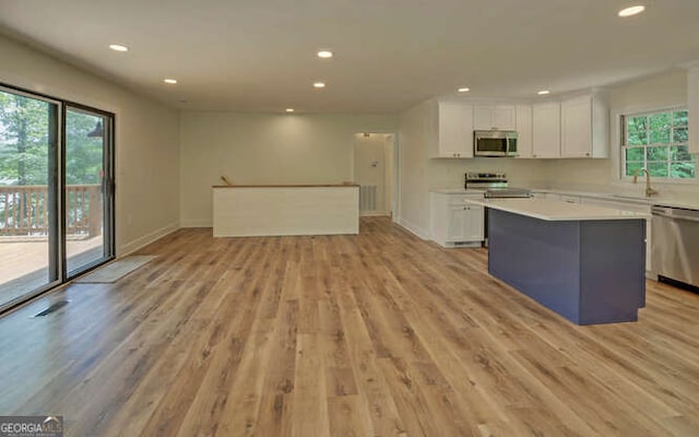 340 Currahee Trl, Toccoa, GA 30577 - kitchen featuring stainless steel appliances, white cabinets, recessed lighting, open floor plan, and a kitchen island