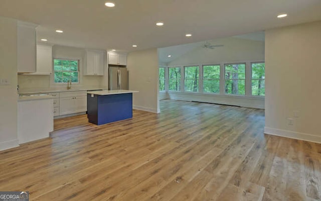 340 Currahee Trl, Toccoa, GA 30577 - kitchen with freestanding refrigerator, open floor plan, a center island, white cabinetry, and a ceiling fan
