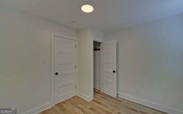 340 Currahee Trl, Toccoa, GA 30577 - unfurnished bedroom featuring light wood-style floors, baseboards, and a closet